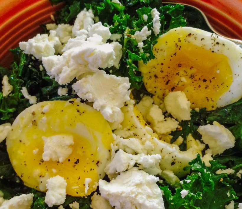 Soft boiled egg with sauteed kale and goat cheese